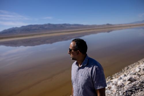 Arrash Agahi, who oversees regulatory compliance of Owens Lake for the Los Angeles Department of Water and Power, looks at an area of the lakebed that has been converted to a brine pool to reduce blowing dust while giving journalists a tour of the project area on Thursday, Aug. 11, 2022. Spenser Heaps, Deseret News